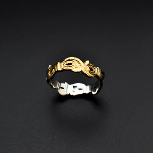 The text describes a handcrafted ring made of sterling silver and embellished with delicate engravings of leaves. The engravings are inspired by nature's beauty and the delicate veins of leaves. The ring also features a subtle glimmer of 22-karat gold infused using the traditional Keum-Boo technique.  This ring is a perfect example of the fusion of nature's artistry with the craftsmanship of human hands. It embodies elegance, individuality, and a timeless appreciation for the beauty of nature.