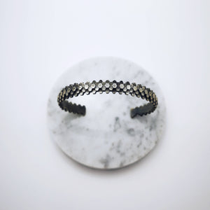 Elegant handcrafted silver braceletet inspired by a specific angular rock formation in Ireland. The bracelet is oxidized.