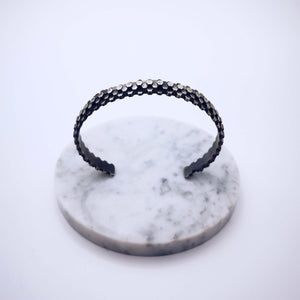 Elegant handcrafted silver braceletet inspired by a specific angular rock formation in Ireland. The bracelet is oxidized.