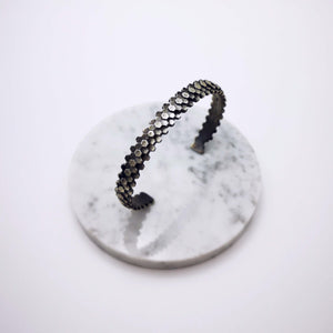 Elegant handcrafted silver braceletet inspired by a specific angular rock formation in Ireland. The bracelet is oxidized.