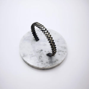 Elegant handcrafted silver braceletet inspired by a specific angular rock formation in Ireland. The bracelet is oxidized.