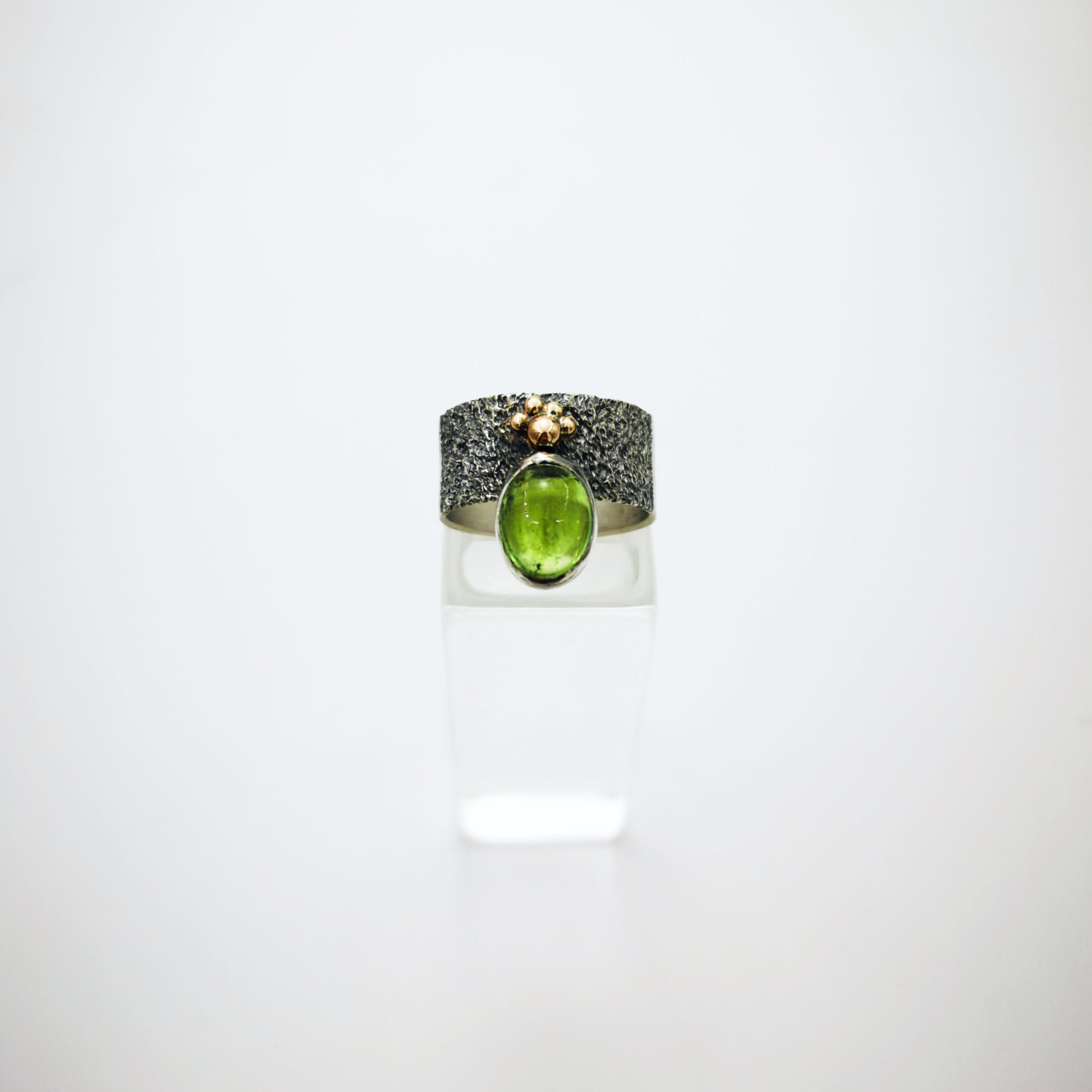 Silver ring with green tourmaline and gold granules