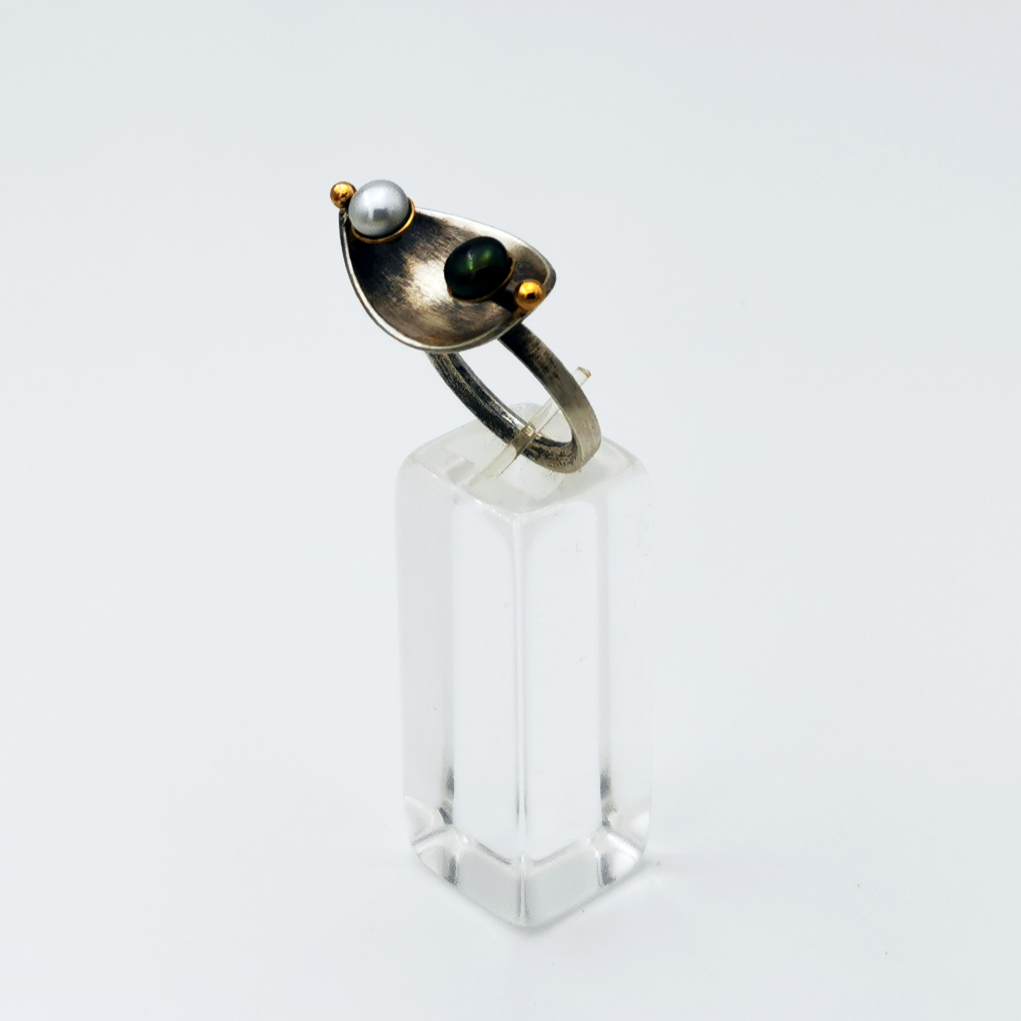 Handcrafted silver ring with 2 gold granules and a pair of black and white pearls.Silver ring oxidized with gold.