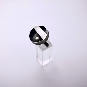 Minimal handcrafted silver ring with a natural white pearl at the centre of the ring, inspiration came from a zen garden in Japan. The ring is oxidized.