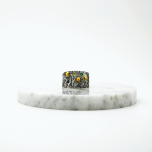 Handcrafted rough surface ring with three gold granules 14 Karat and with coloured natural zirconian green,yellow and blue.