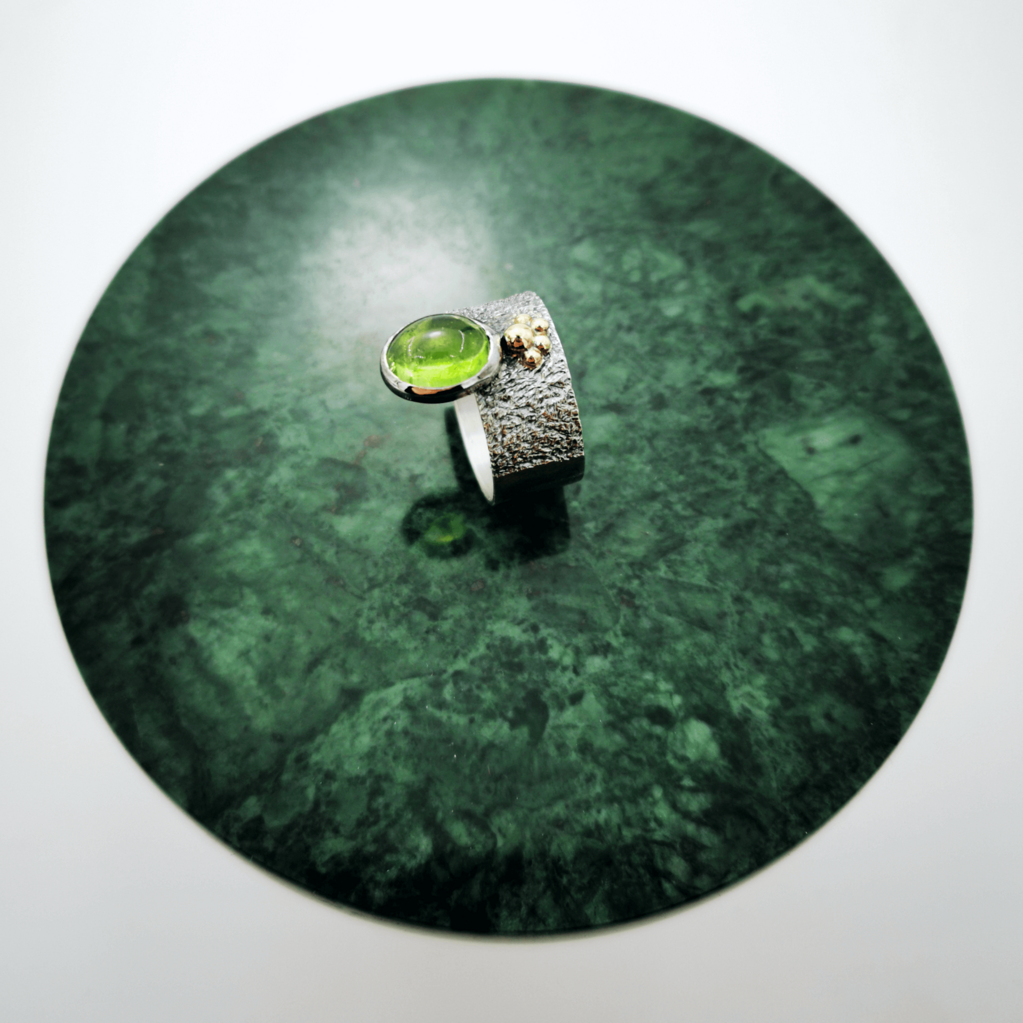 Silver ring with green tourmaline and gold granules