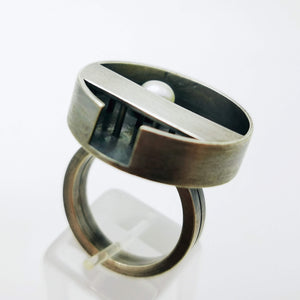 Minimal handcrafted silver ring with a natural white pearl at the centre of the ring, inspiration came from a zen garden in Japan. The ring is oxidized.