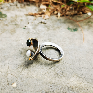 Handcrafted silver ring with 2 gold granules and a pair of black and white pearls.Silver ring oxidized with gold.