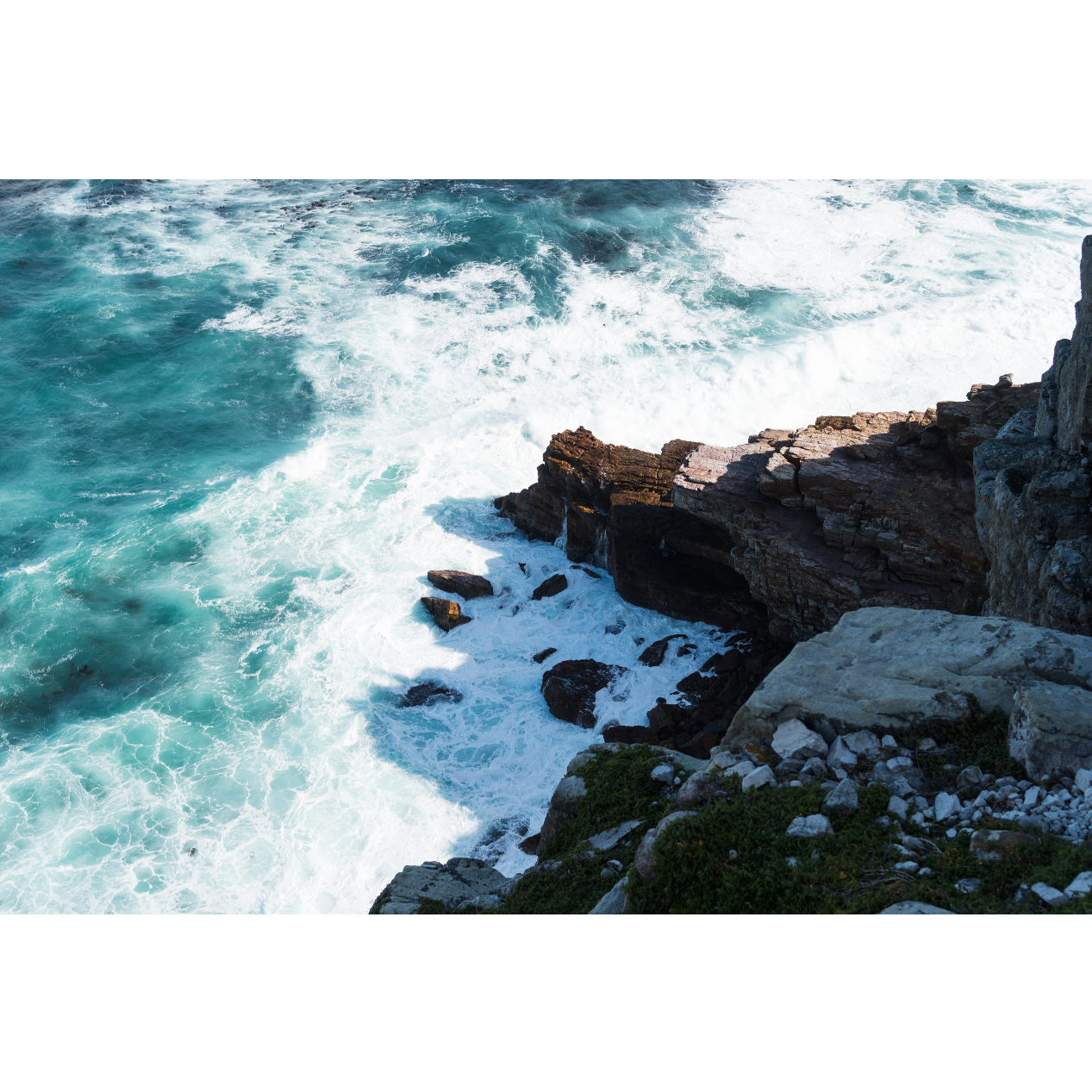 Picture of a rock formation surround it by water